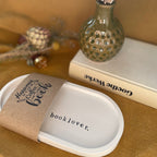 Handgefertigtes Deko-Tablett Booklover – das perfekte Geschenk für Leseratten, Bücherliebhaber und kreative Seelen. Aus weißer Keramik, mit typografischer Prägung in eleganter Serifenschrift. Für Leseecken, Nachttische oder als stilvolle Bücherregal-Deko. Echtes Handwerk, gefertigt mit Liebe zum Detail.
